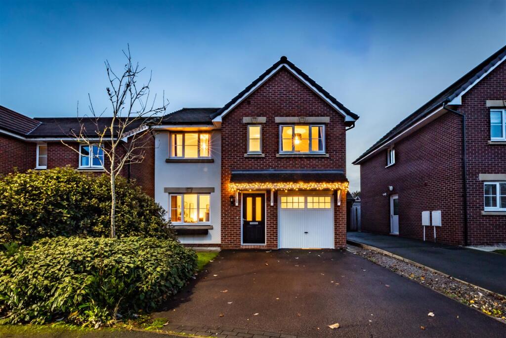 Main image of property: Impeccably styled, detached property in a prized contemporary development