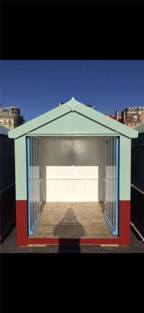 Colourful beach huts on the promenade at Hove Gardens, East Sussex