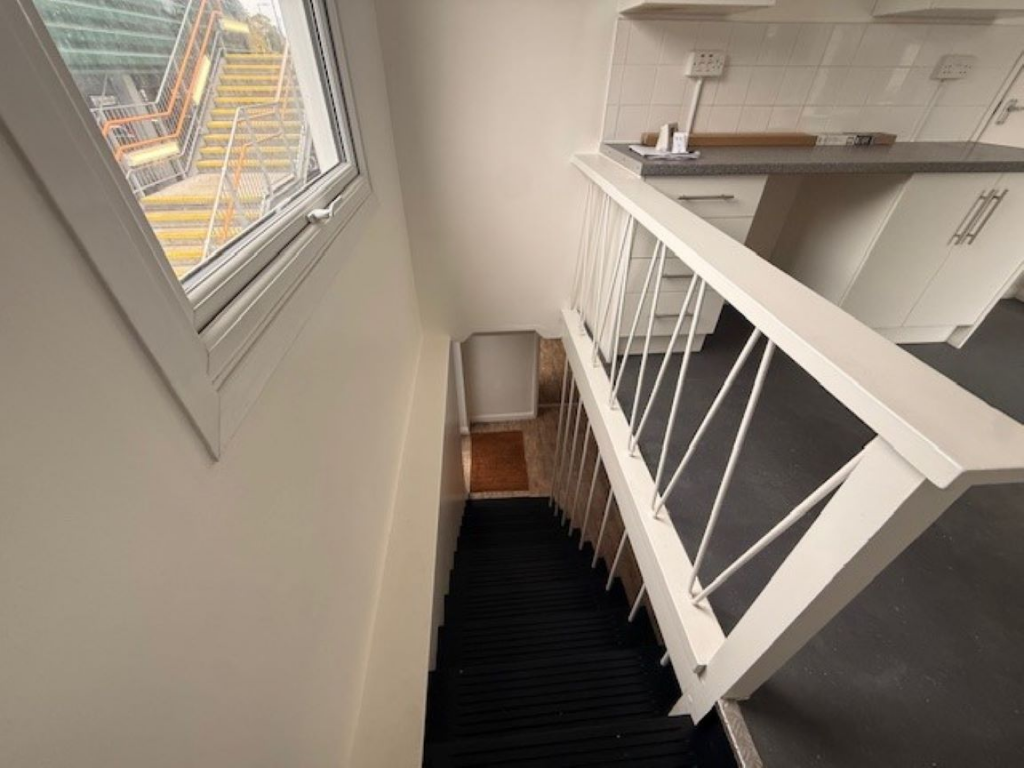 An estate, with multiple arches next to each other. The arches have closed electric roller shutter entrances.