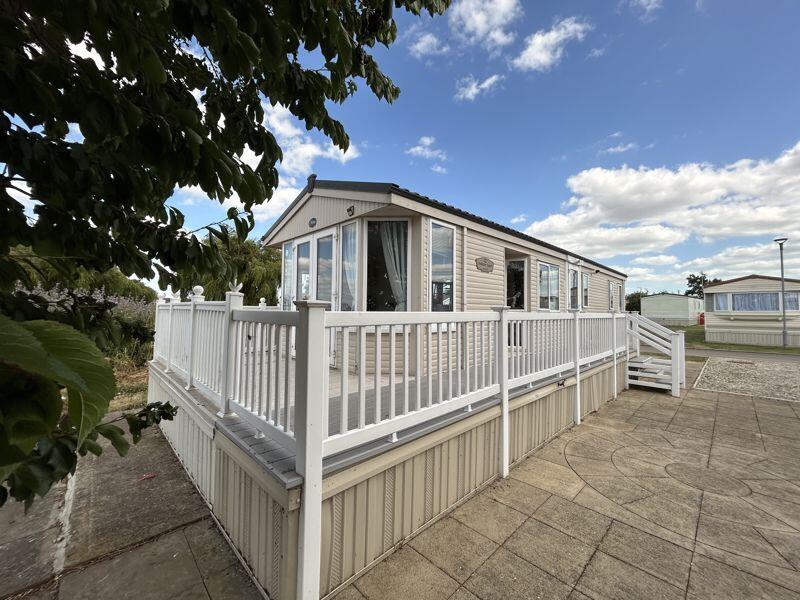 Main image of property: Decked holiday lodge in stunning location. 