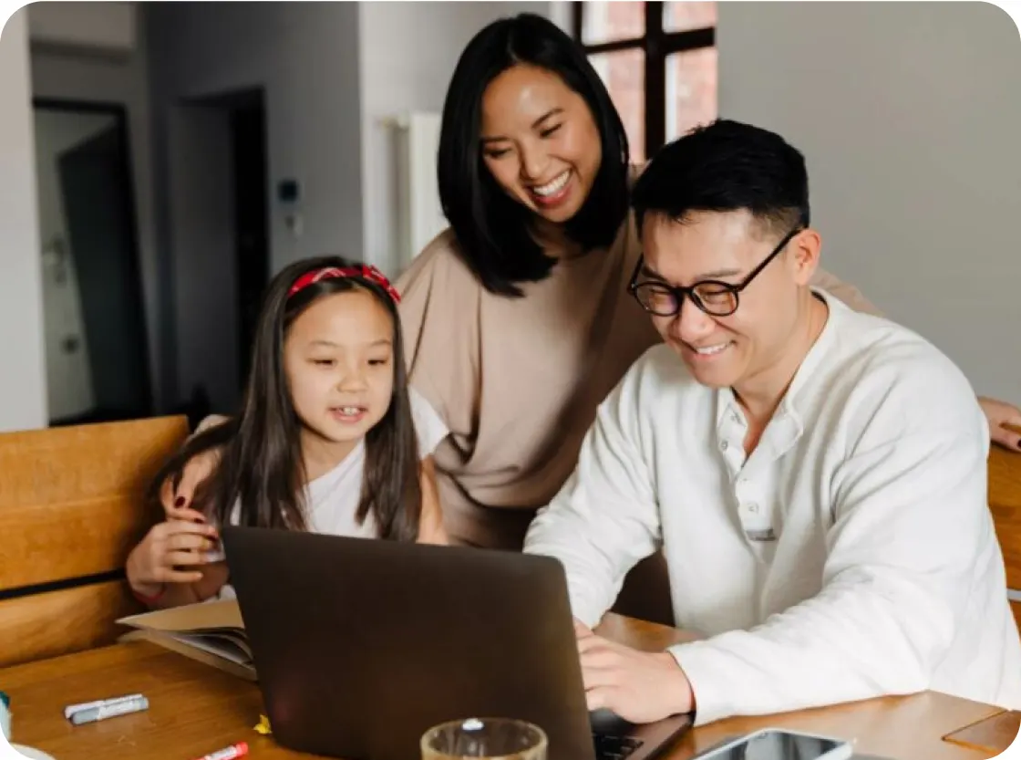 Image of a family looking at a laptop