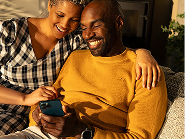 Two happy people looking at phone