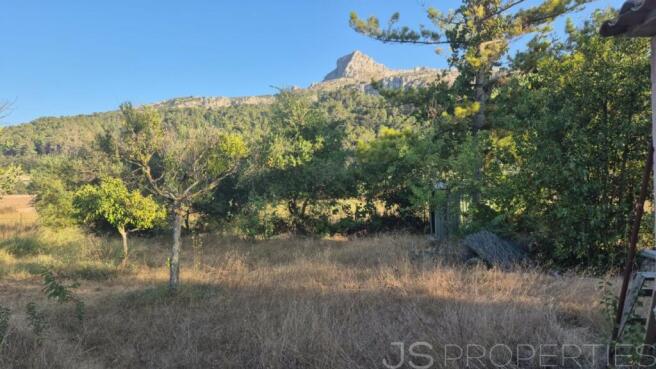 Land with small house 