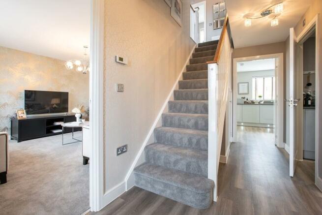 Inviting hallway with useful storage cupboard