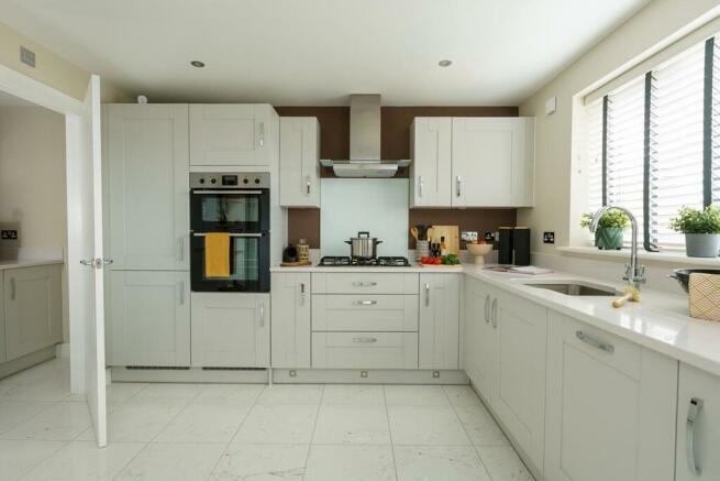 The L-shaped modern kitchen offers ample storage space