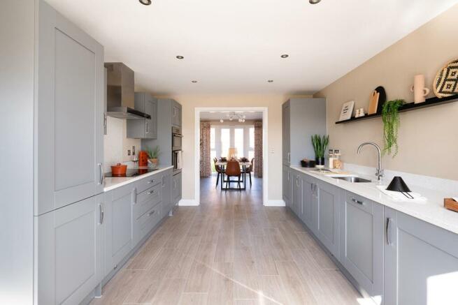 The kitchen leads through double doors to the separate dining room