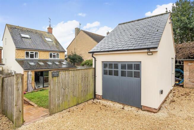 Level rear driveway access and garage