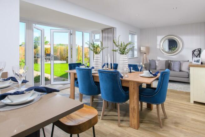 Open-plan kitchen/diner with glazed bay leading to garden in Bradgate style home
