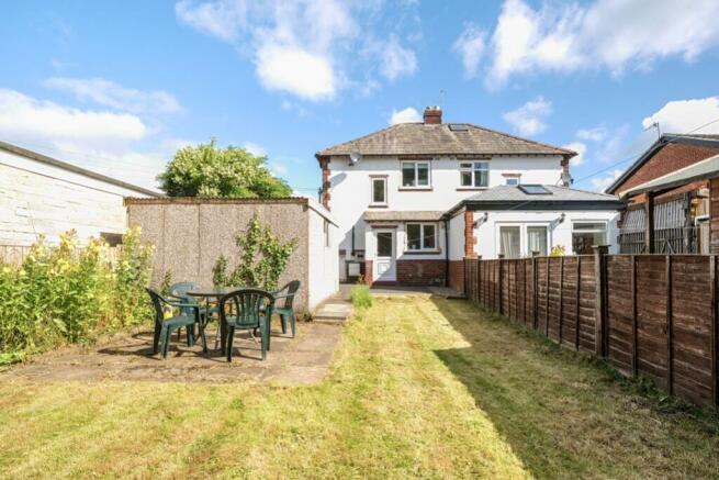 Rear garden and view of property