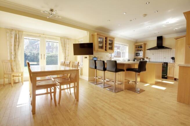 Taken from the dining area showing the kitchen are