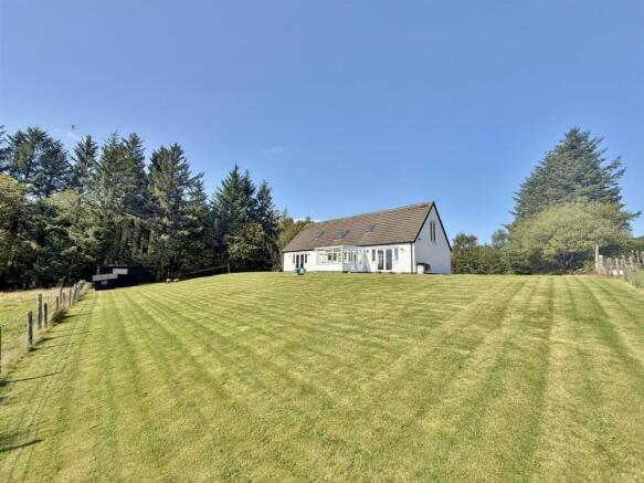 Front garden and wooded area