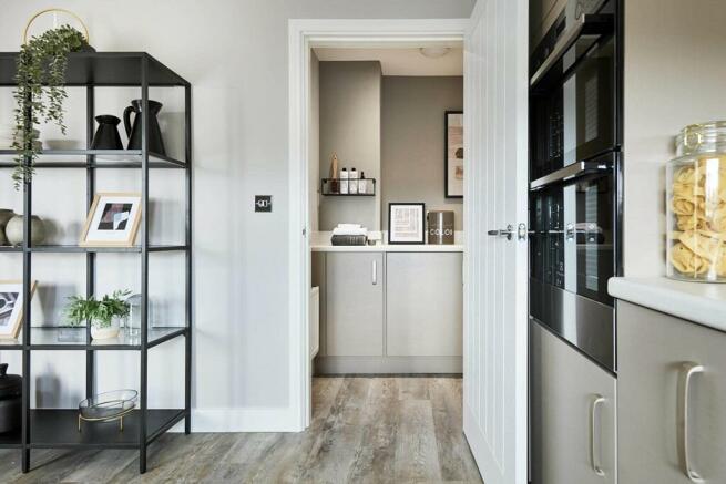 An adjoining utility area leads from the kitchen