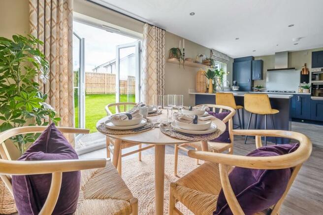 The dining space enjoys views of the garden through French doors