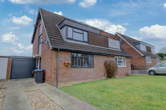 Front with driveway parking and garage