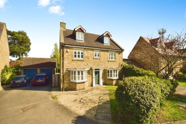 Outside View Of The Property With Double Garage and Driveway Parking
