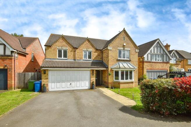 Outside View Of The Property With Driveway Parking & Garage