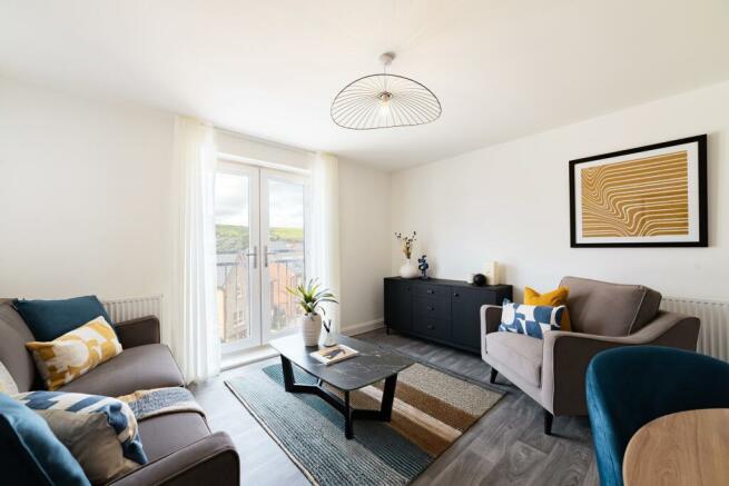 Internal shot of the open plan lounge and dining area with juliet balcony