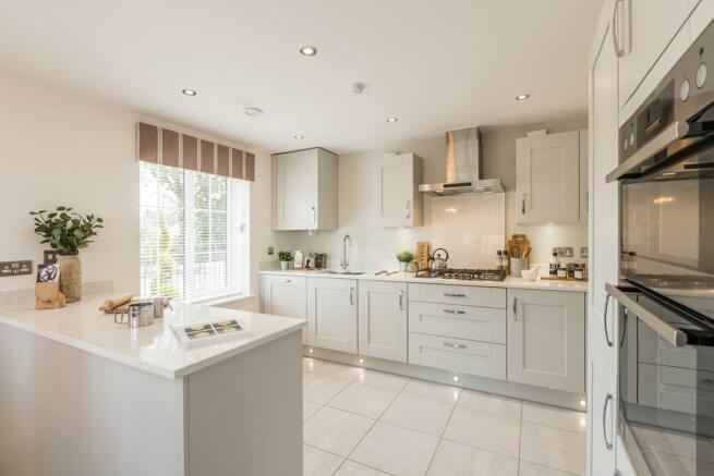 A bright open plan kitchen with handy peninsular worktop