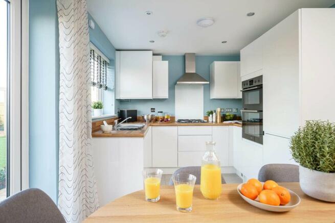 An a bright and airy kitchen and dining area opens through double doors to the garden, perfect for