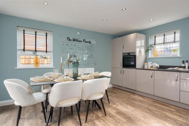 Inside view of the Alderney open plan kitchen with dining area. 4 bed home.