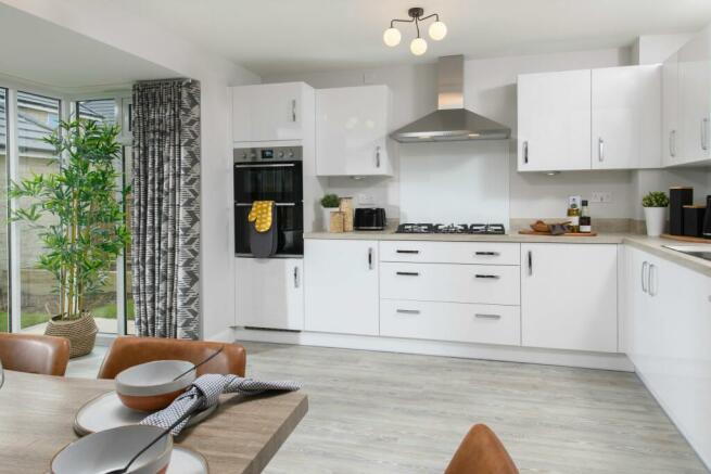 Open-plan kitchen/dining area with glazed bay leading onto garden - Millford style home