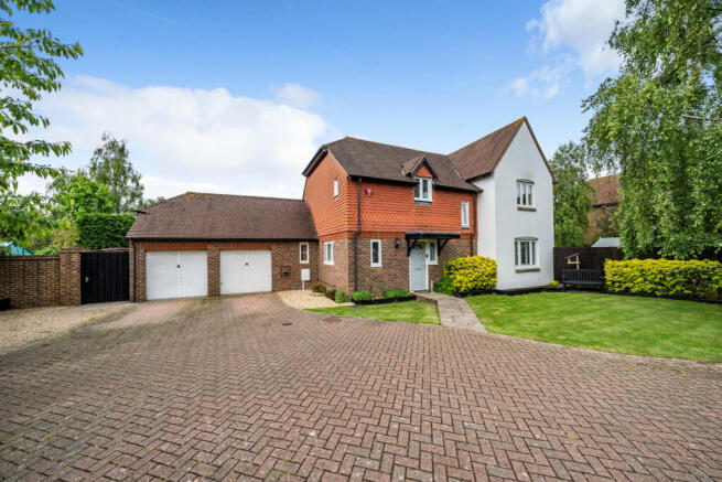 Front elevation with driveway providing parking for up to 5 vehicles