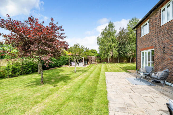 Private South West facing rear garden overlooking field and woodland