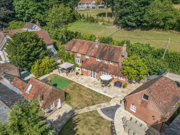 View over the house, garden, garage and outbuilding