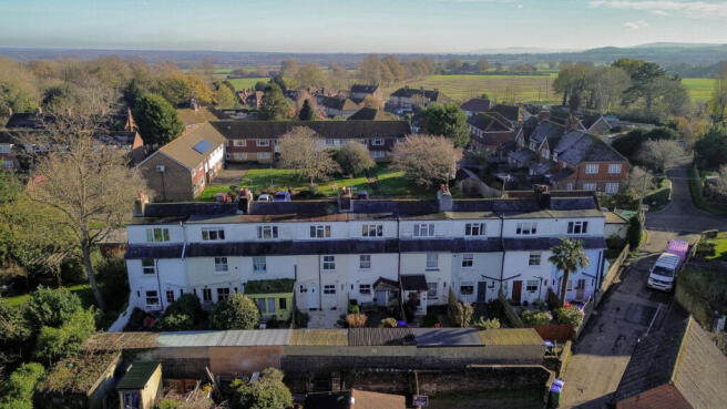 Elevated view over the house showing open countryside and walks beyond