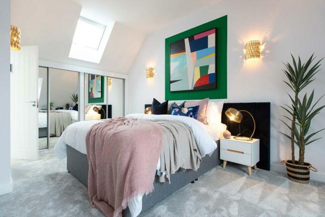 The main bedroom features space for a dressing area, and skylight windows