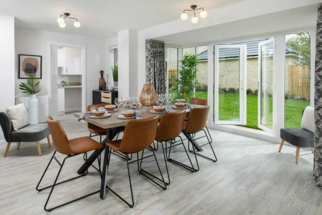 Open-plan kitchen/dining area with glazed bay leading onto garden - Millford style home