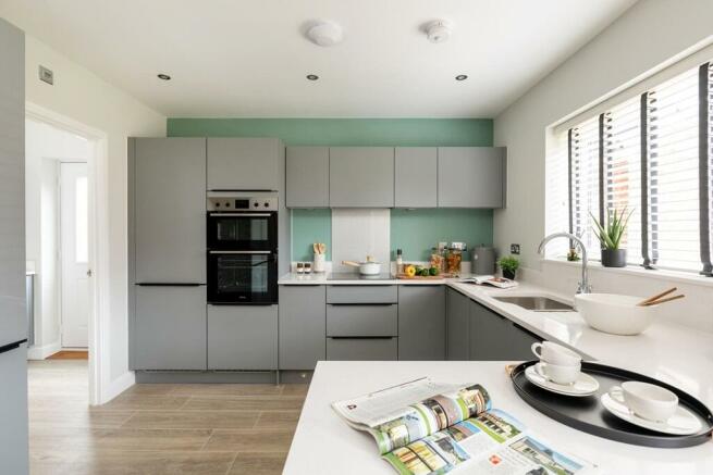 Modern kitchen offers lots of storage space and a separate utility room