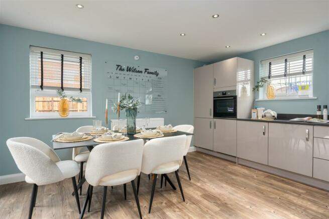 Inside view of the Alderney open plan kitchen with dining area. 4 bed home.