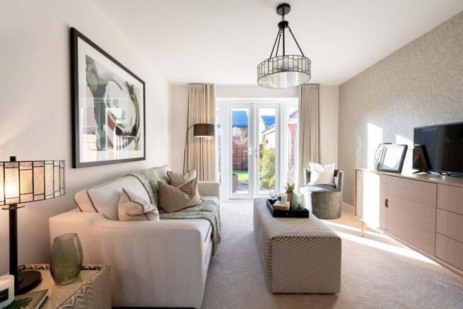 Living room filled with natural light from french doors to the garden