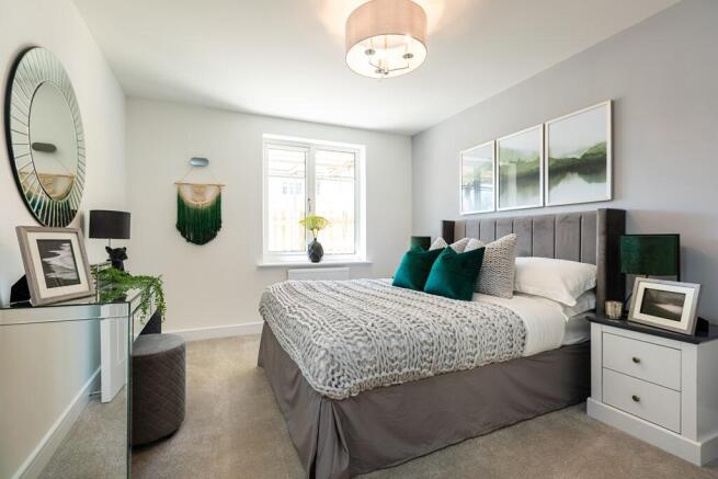 A generous bedroom has space for a double bed and optional storage