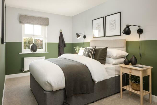 Green coloured double bedroom in a 3 bed home