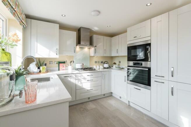 The kitchen is spacious with ample storage