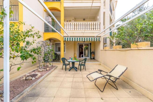 Campoamor ground floor apartment with spacious terrace and has communal pool located 800m from beach