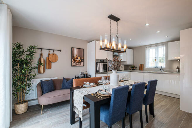 Modern kitchen with white cupboards and dining table