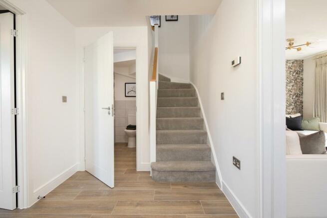 A welcoming hallway with storage and downstairs toilet