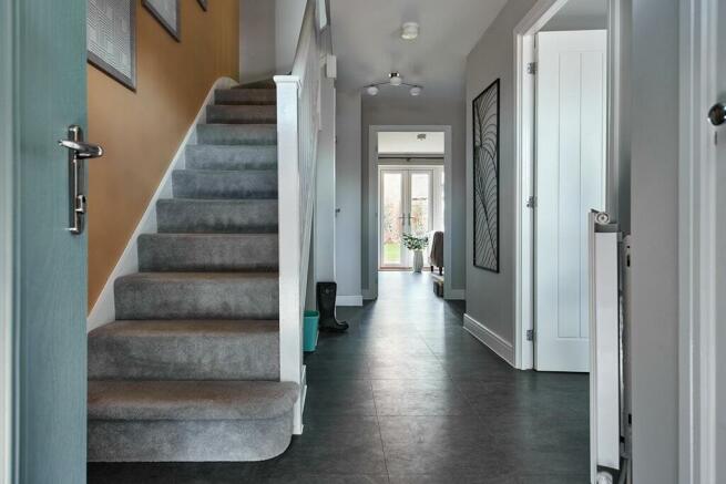 Hallway with convenient storage cupboard and cloakroom