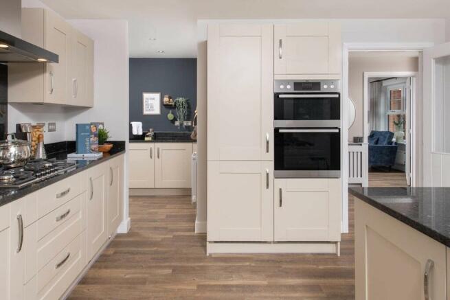 A handy utility area leads from the kitchen, perfect for a laundry area