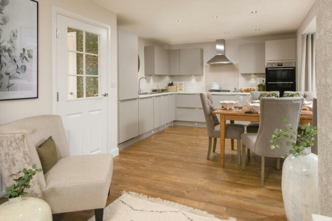 Open-plan kitchen with integrated appliances, dining area & family room with French doors leading on