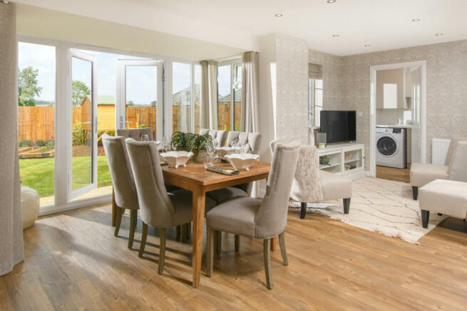 Open-plan kitchen with integrated appliances, dining area & family room with French doors leading on
