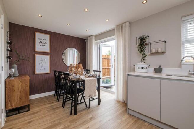 Photo of the Archford kitchen diner, French doors open on to the garden behind the table