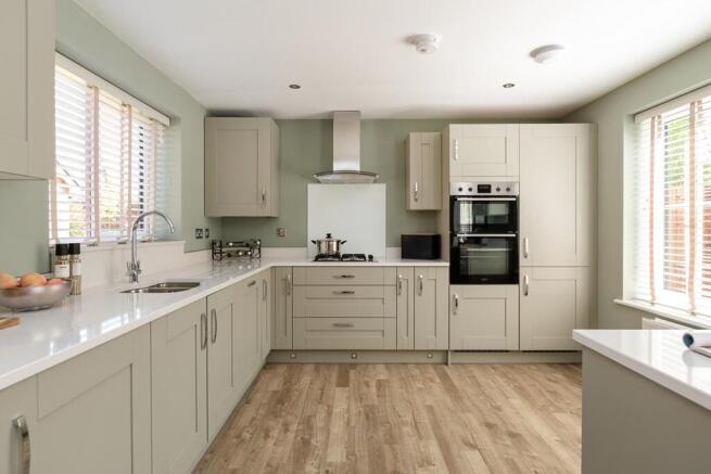 The modern kitchen has ample storage space and a stylish breakfast bar