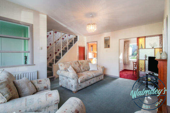 Sitting room with doors to kitchen & dining