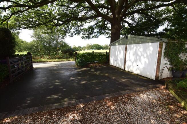 main entrance and detached double garage