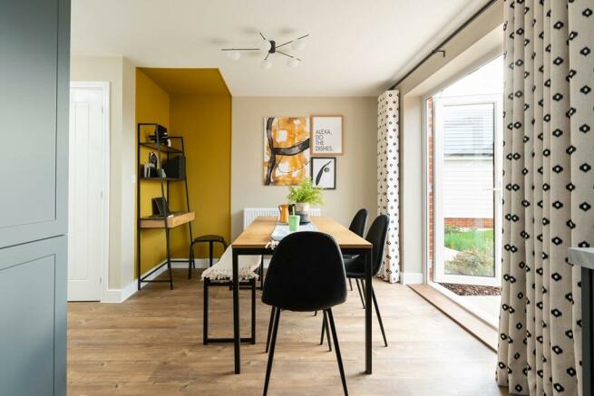 The open-plan kitchen features double doors to the garden