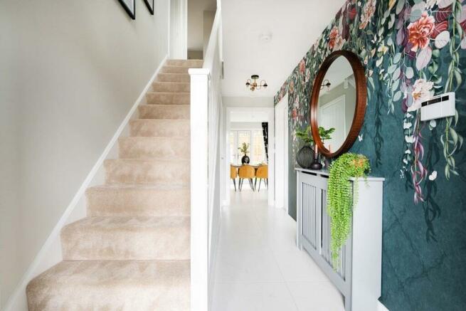 The hallway is welcoming and includes under stairs storage